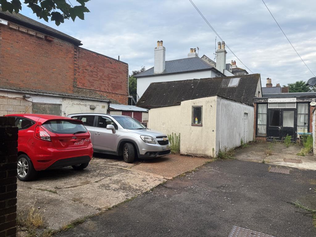 View of parking arwa at rear with outbuildings