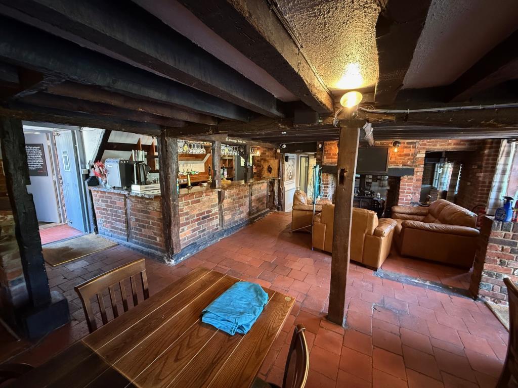 Traditional pub serving area with exposed ceiling