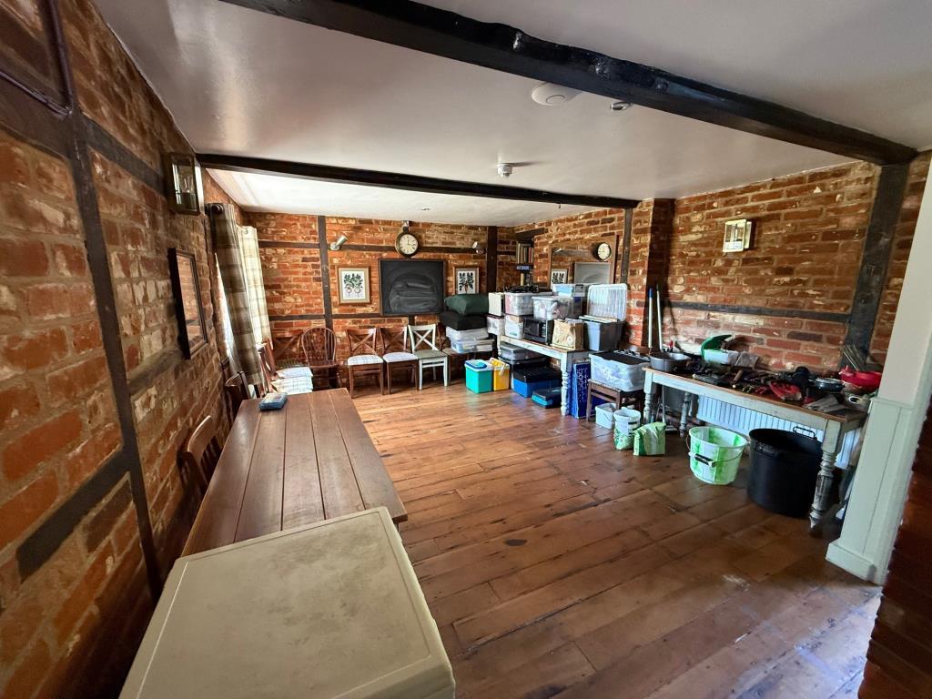 Storage area with exposed brick walls and wooden f