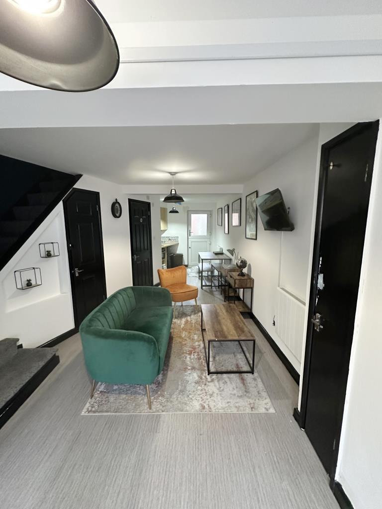 Ground floor with white walls and grey flooring