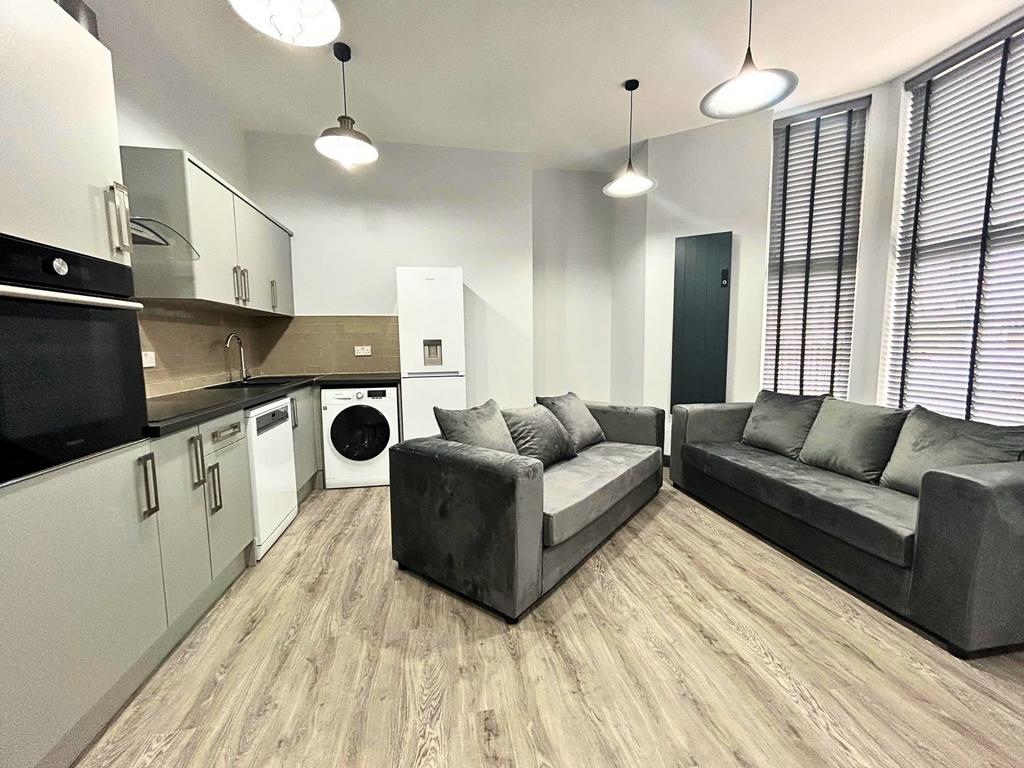 Bright, modern living room with comfortable gre...