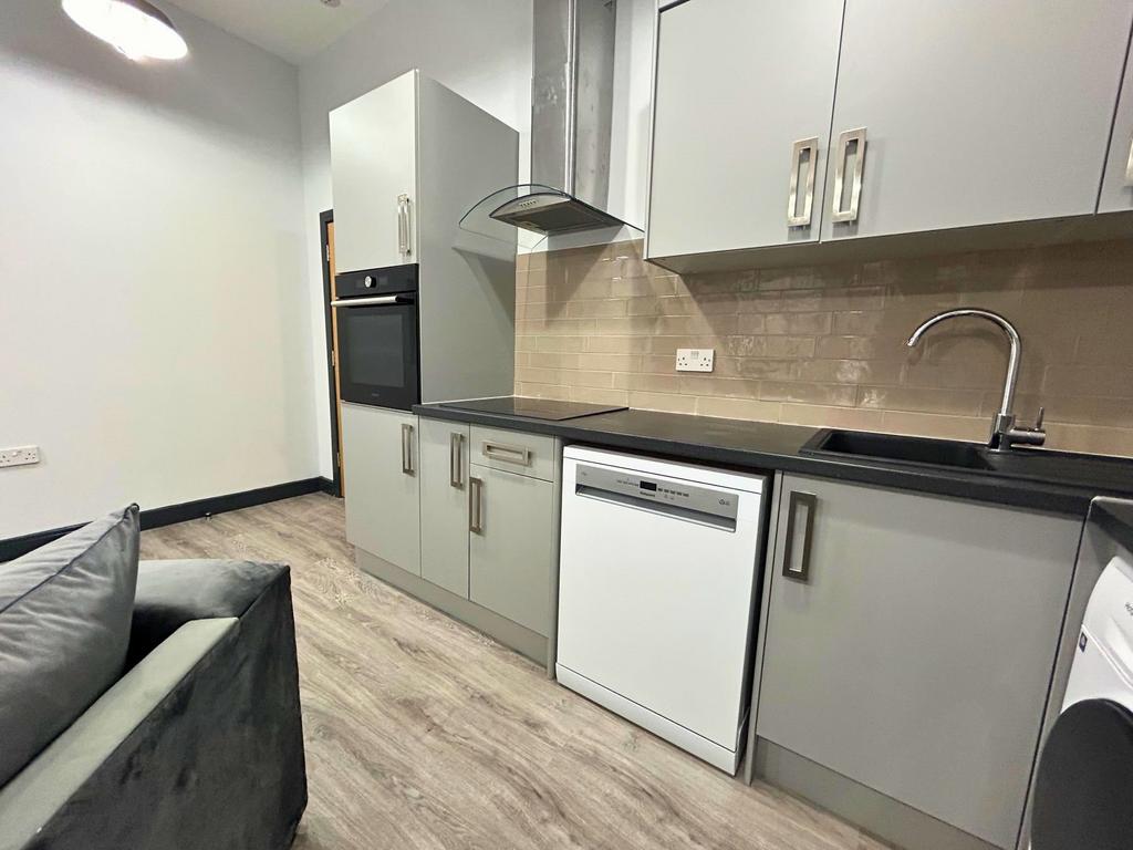 Modern kitchen area featuring sleek grey cabine...