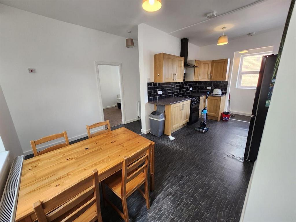 Bright, modern kitchen/dining space with a wood...