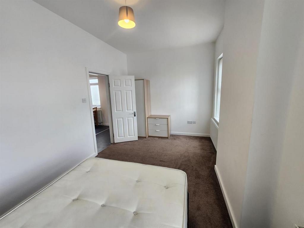 Bright, neutral bedroom with fresh white walls,...