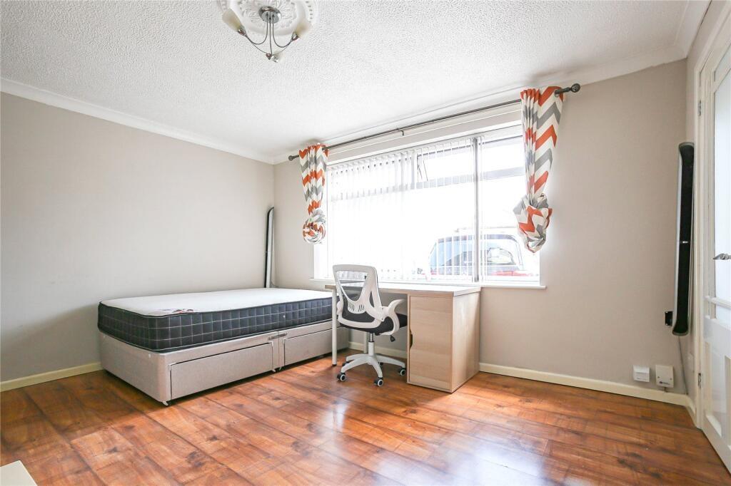 A bright and clean single bedroom featuring a c...