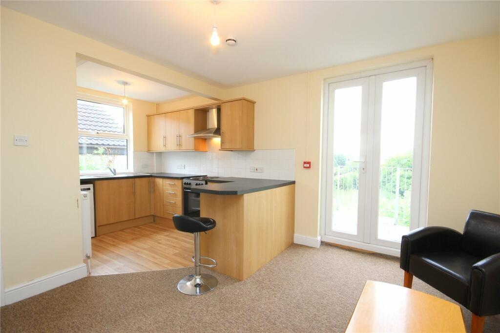 Bright and tidy kitchen area featuring modern w...
