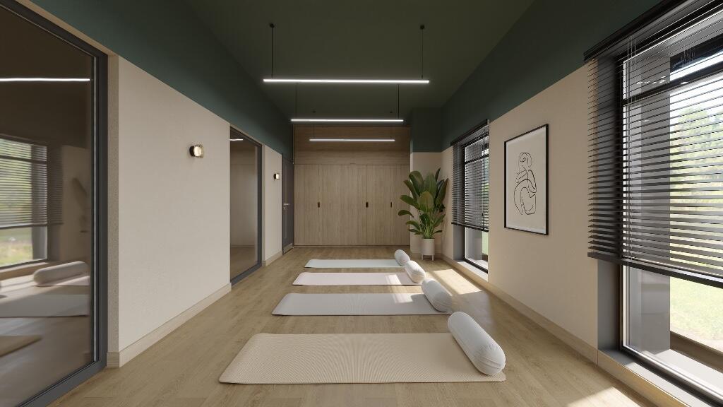 A modern, well-lit yoga studio with several mat...