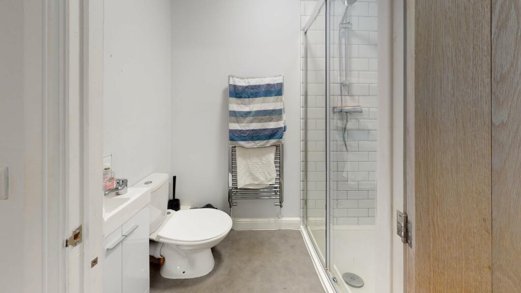 A modern and clean bathroom suite featuring a s...