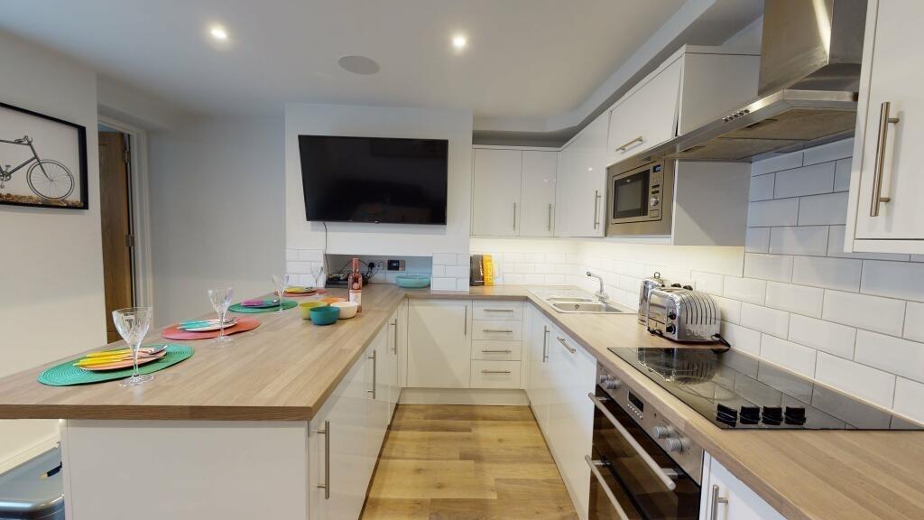 Bright and modern kitchen featuring a spacious ...