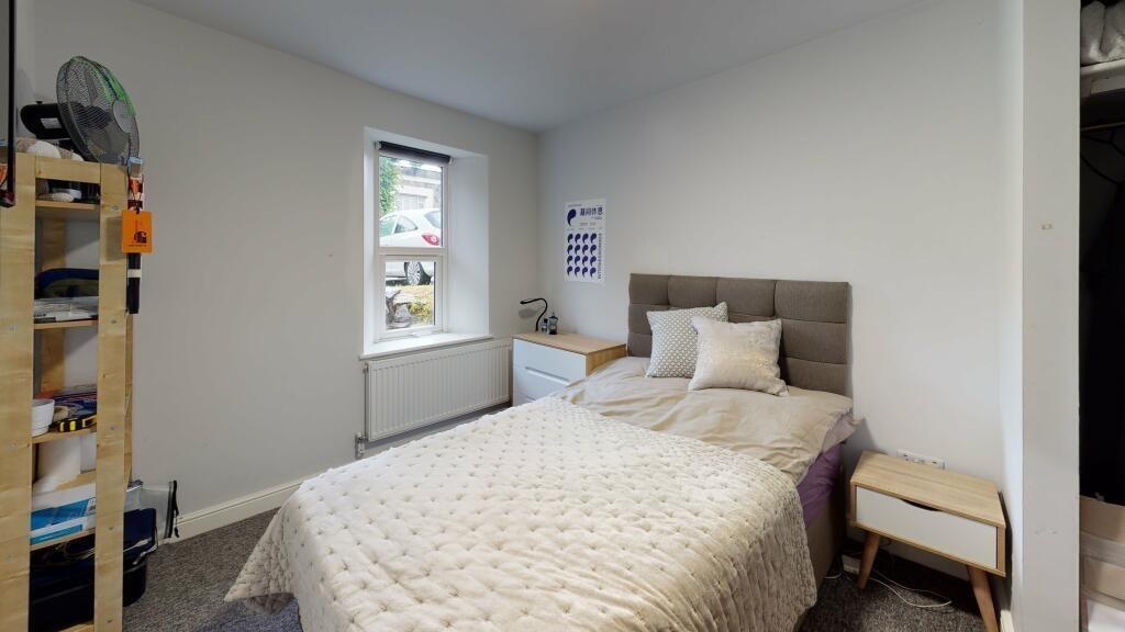 A bright and tidy single bedroom with a comfort...
