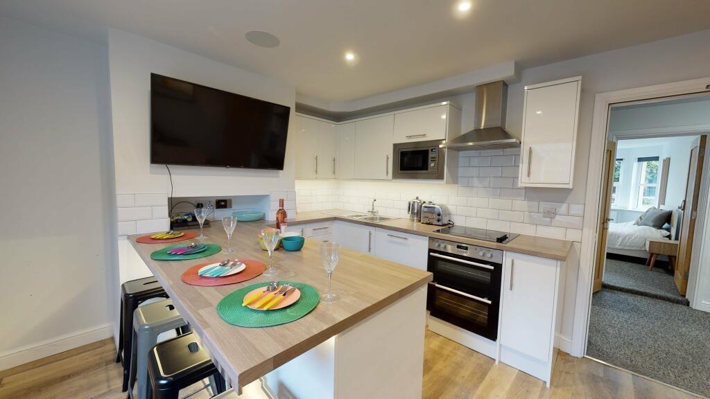 Bright and modern kitchen featuring a spacious ...