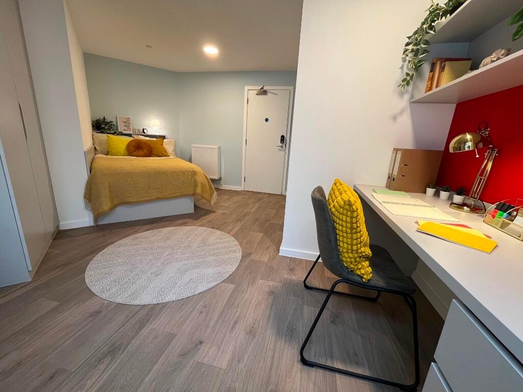 A modern master bedroom featuring a comfortable...