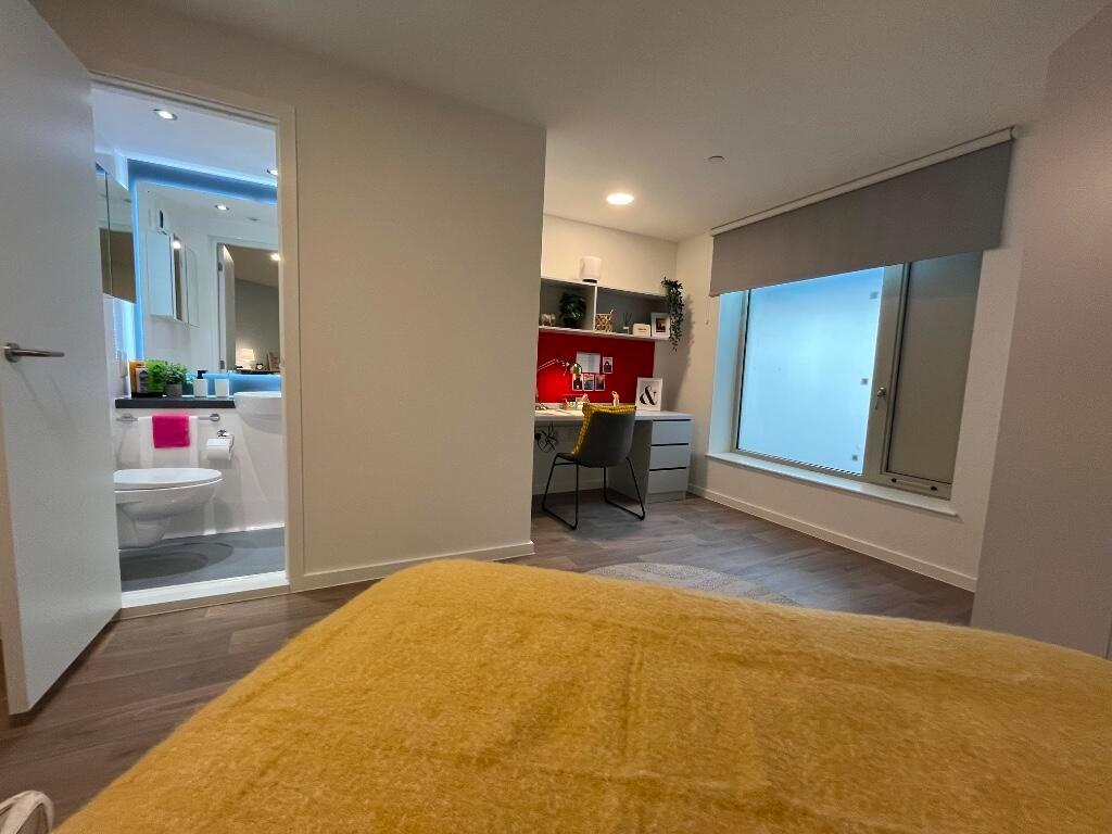 A modern master bedroom featuring a cozy double...