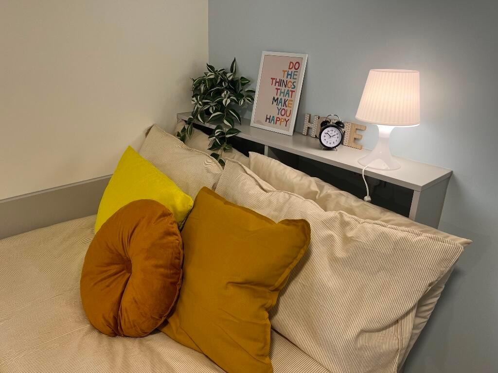 A cozy master bedroom featuring a comfortable b...
