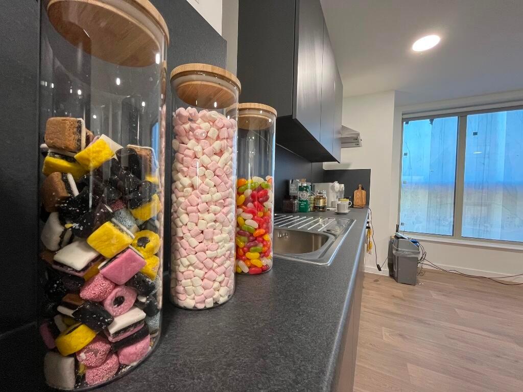 Modern kitchen with clean countertops and jars ...