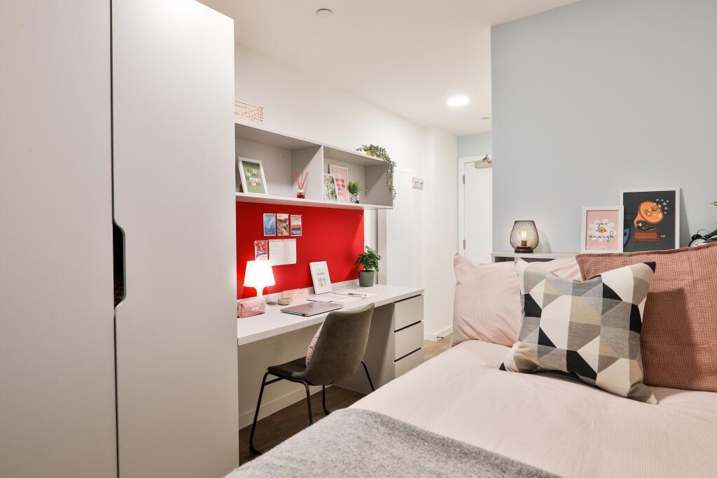 A cozy and well-organized bedroom featuring a c...