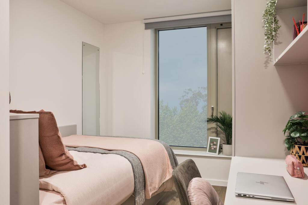 A cozy and neatly arranged single bedroom featu...