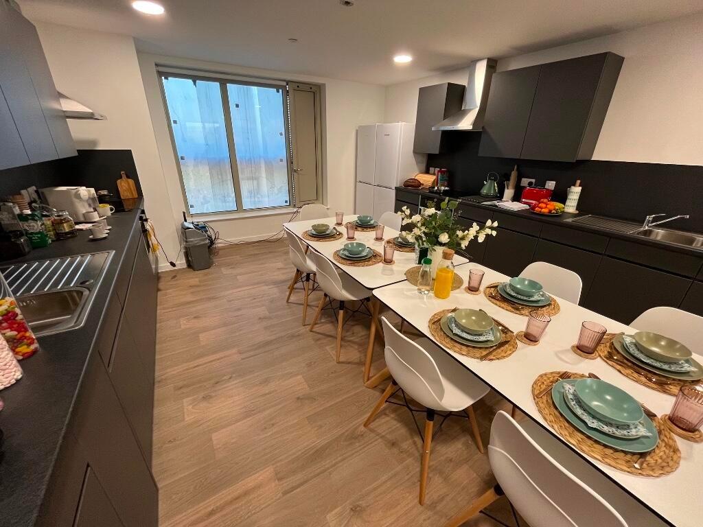 Bright and modern kitchen featuring a large din...