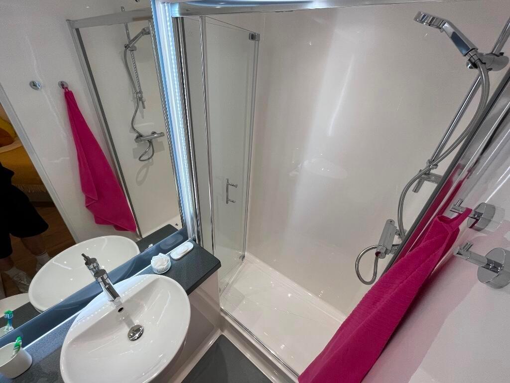 A bright and clean bathroom featuring a spaciou...