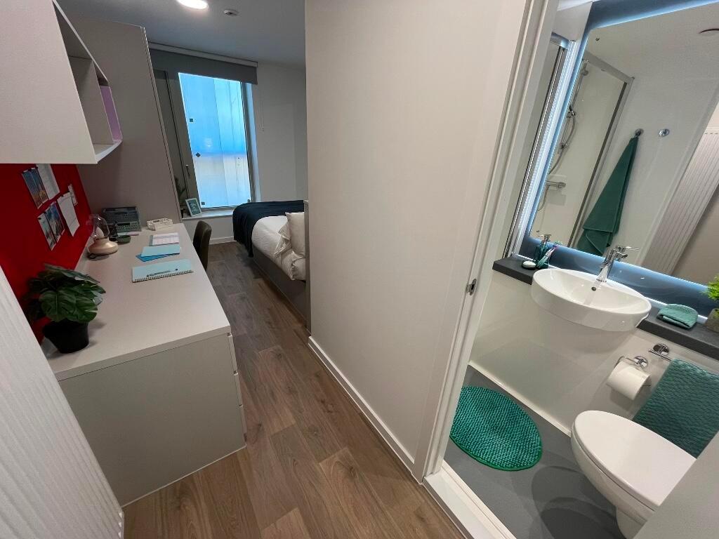 A bright and clean single toilet with modern fi...