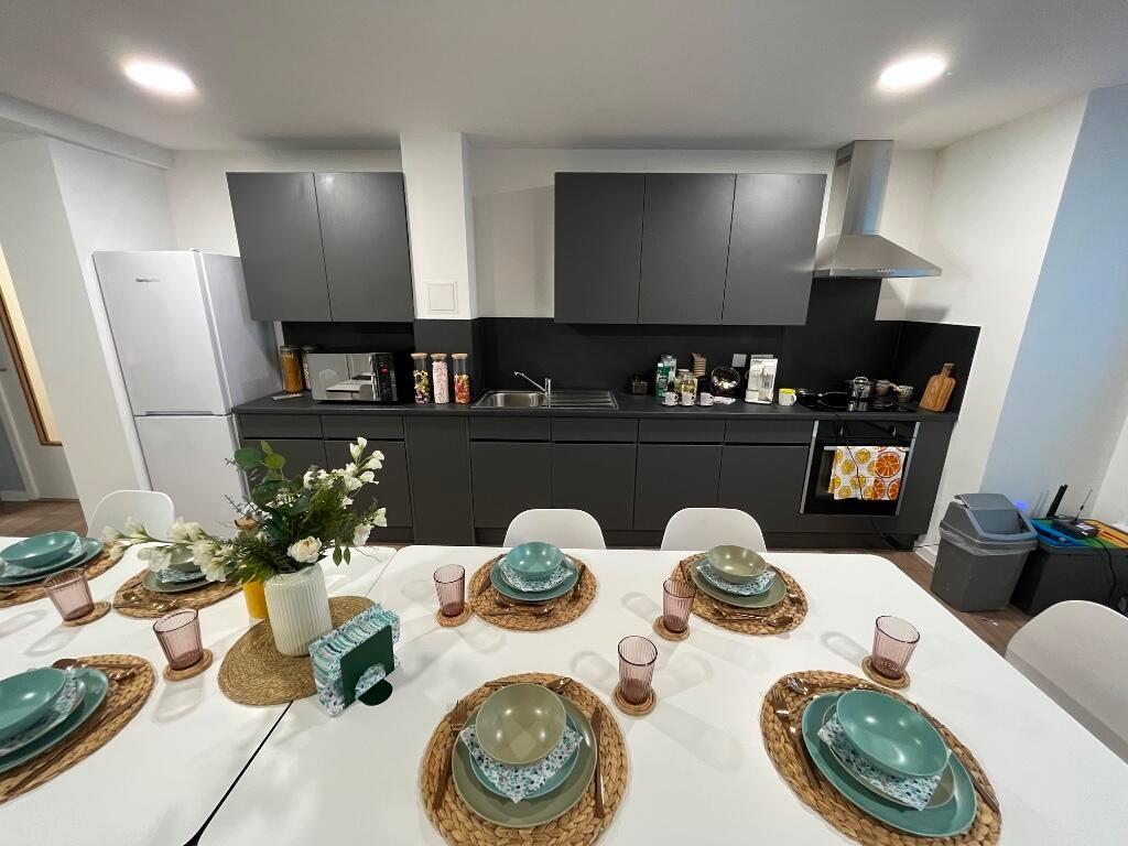 A modern kitchen with sleek black cabinetry and...