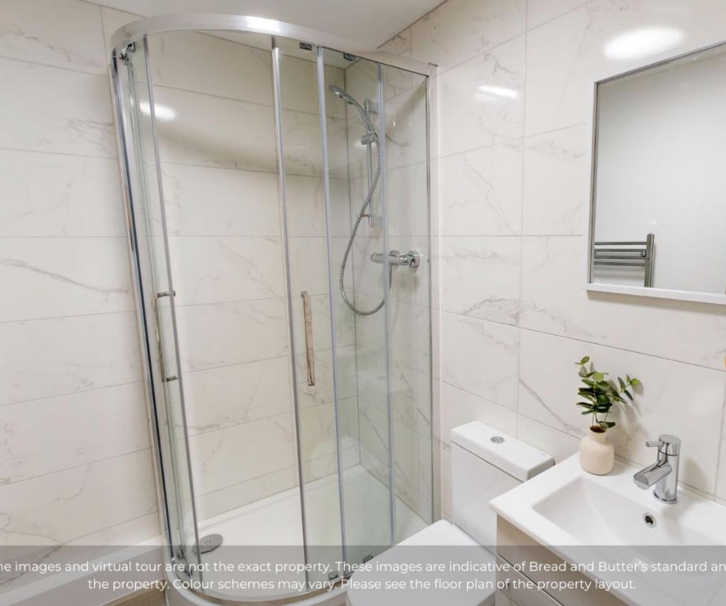 A modern, clean bathroom suite featuring a spac...