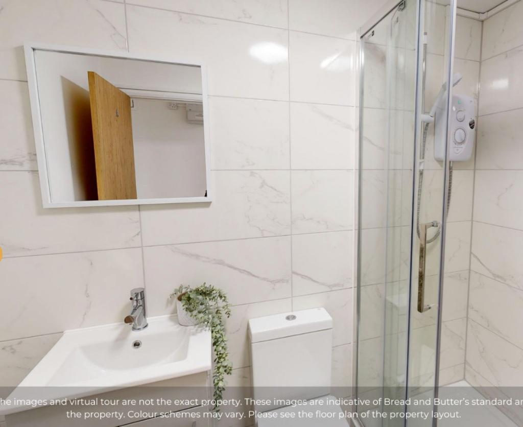 A modern and clean bathroom suite featuring a s...