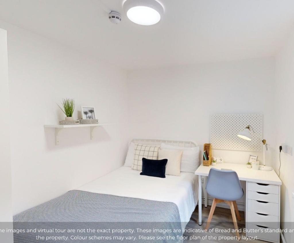 A clean and modern double bedroom featuring a c...