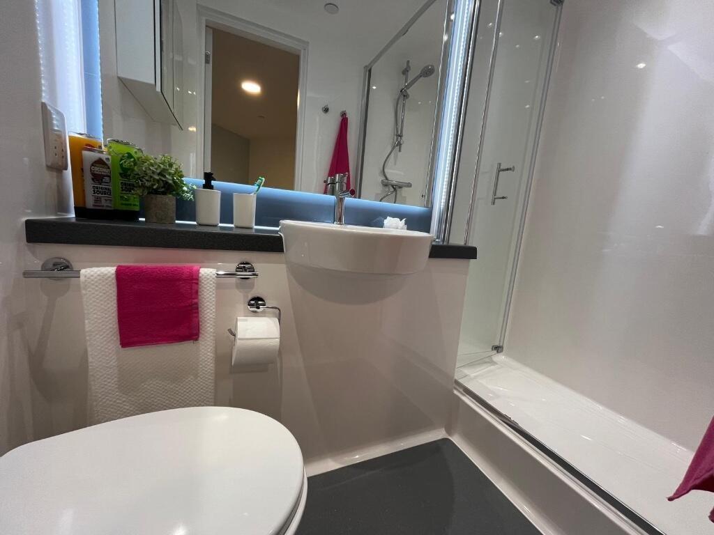 Bright and modern bathroom featuring a clean wh...