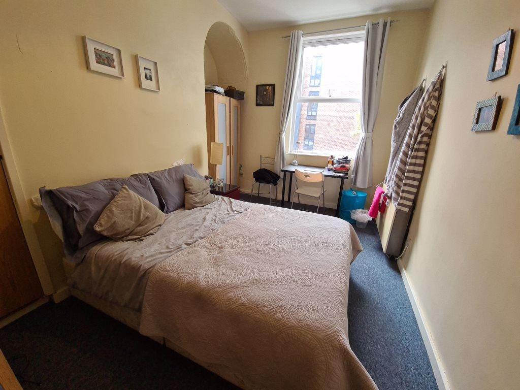 Cozy double bedroom featuring a comfortable bed...