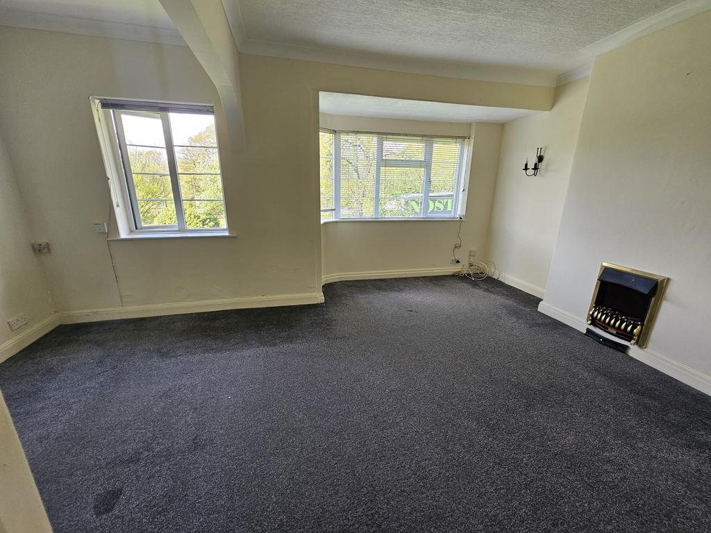 A spacious living room featuring large windows ...