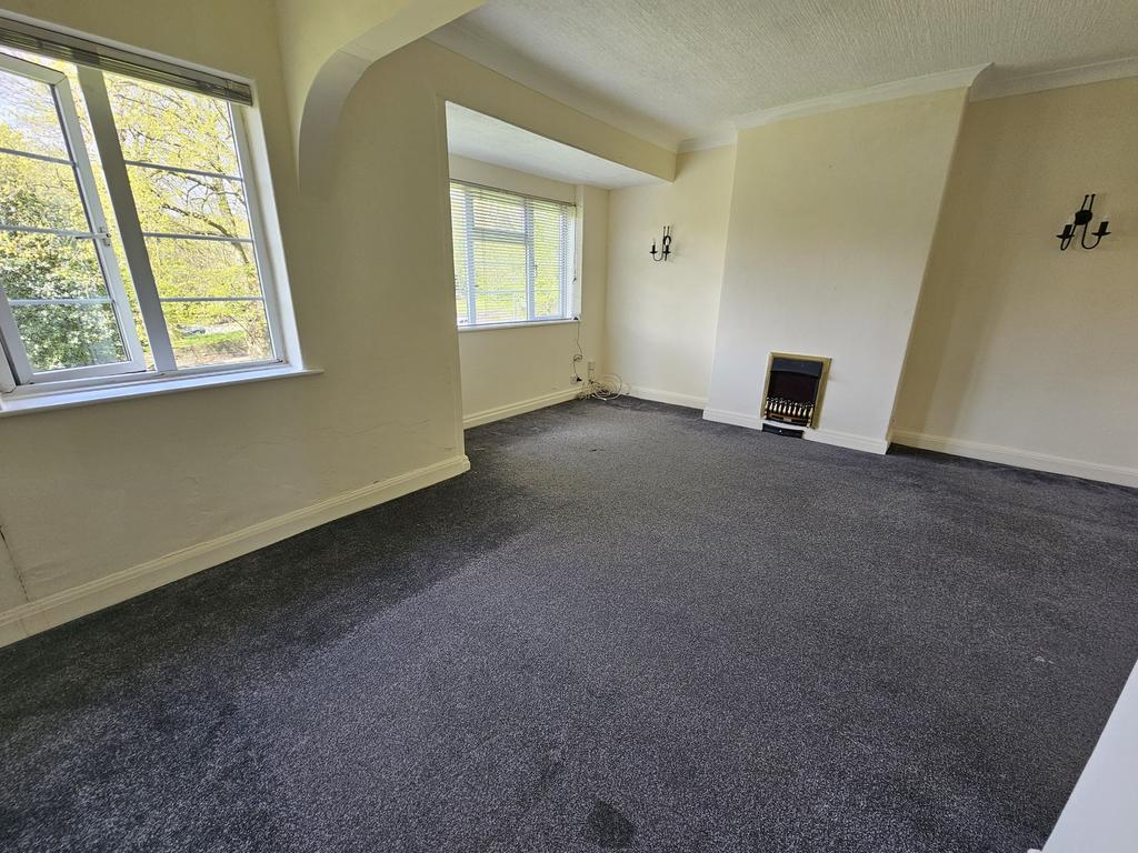 Bright living room with two large windows allow...