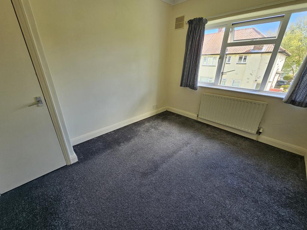 A bright and clean single bedroom featuring a l...