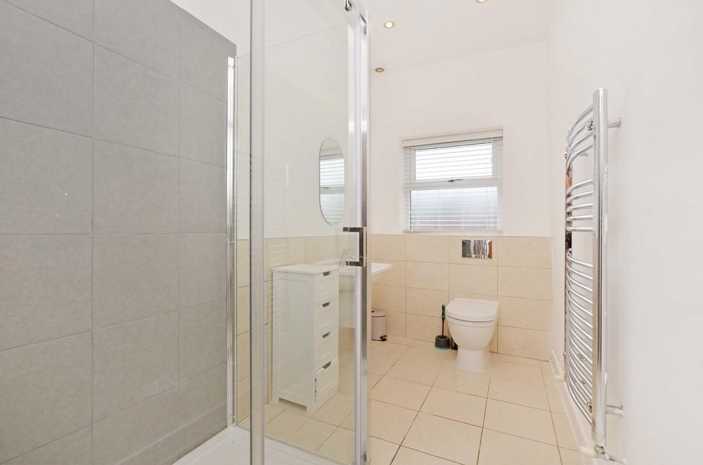 A bright and modern bathroom suite featuring a ...