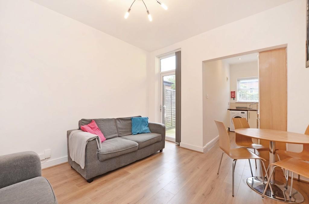 A bright and tidy living room featuring a comfo...