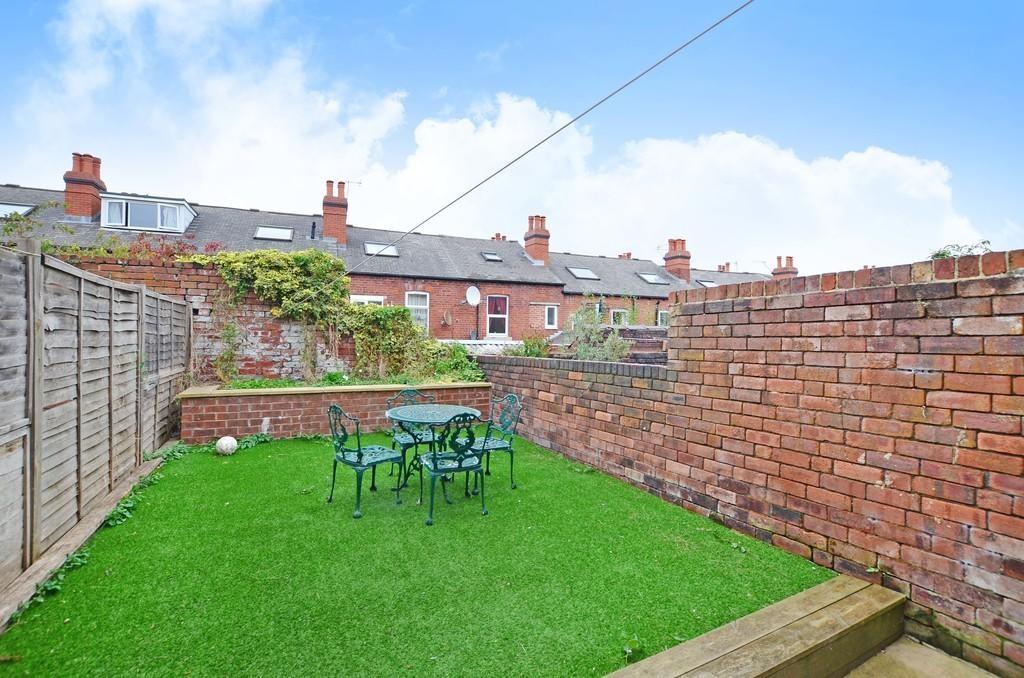 A well-maintained private garden featuring a gr...