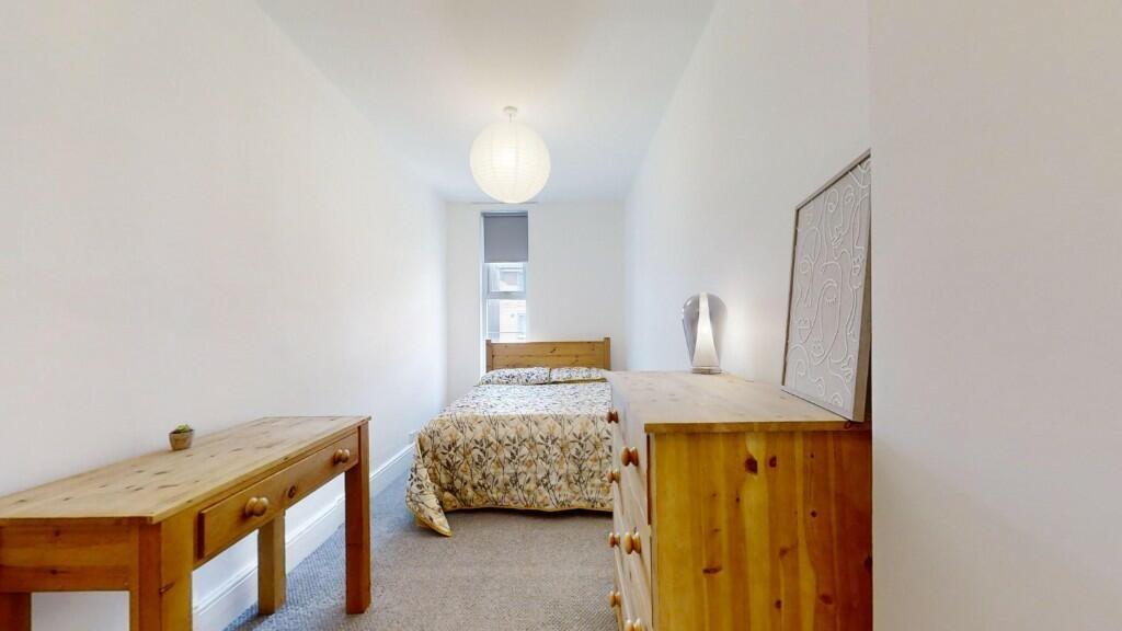 A clean and bright single toilet room with mini...