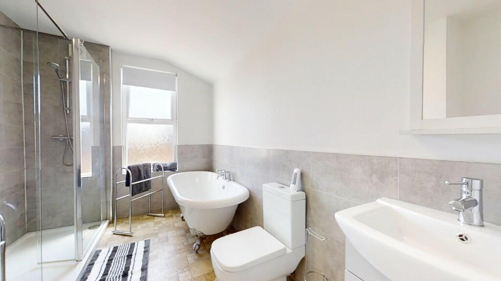 A bright and modern bathroom suite featuring a ...