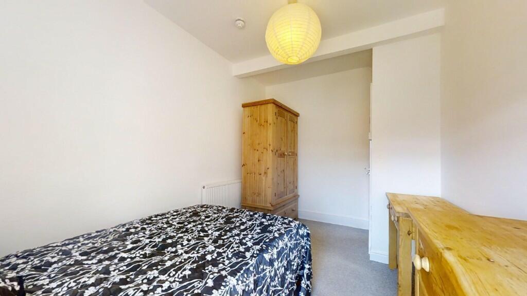 A neat and bright single bedroom featuring a co...