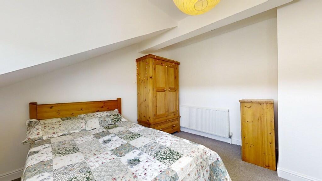 Cozy double bedroom featuring a comfortable woo...
