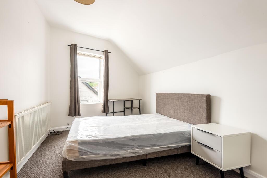 Bright and airy double bedroom featuring a comf...