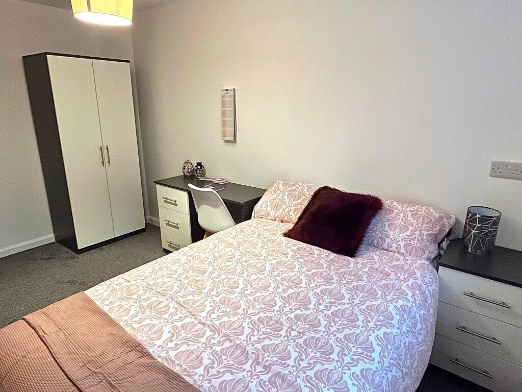 A cozy double bedroom featuring a comfortable b...