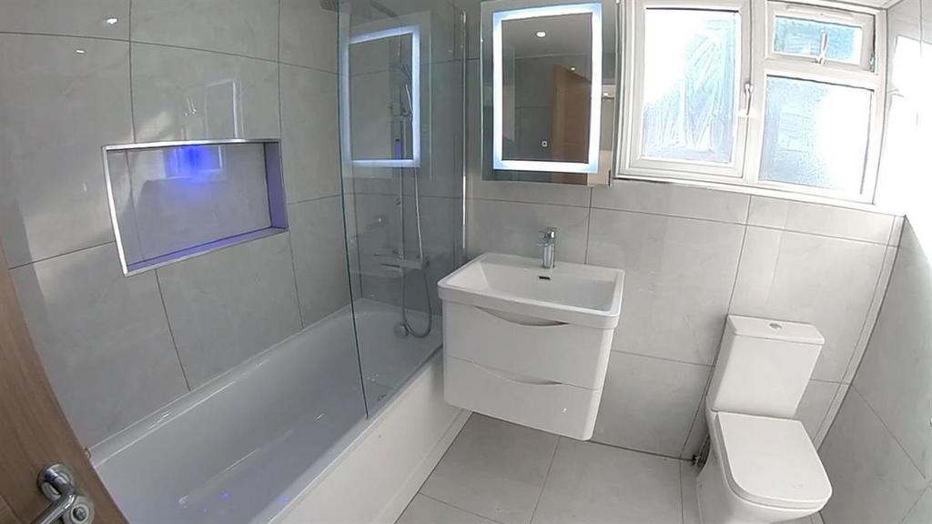 Bright and modern bathroom featuring a bathtub ...