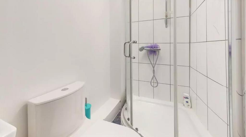 A clean and modern bathroom featuring a shower,...
