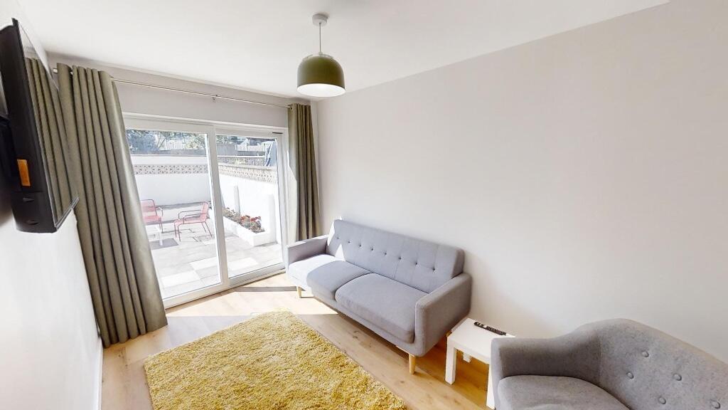 Bright and cozy living room featuring soft grey...