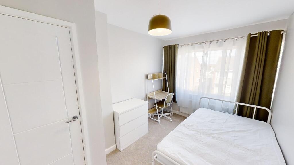A neat and bright single bedroom featuring a co...