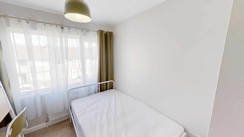 Bright, well-lit single bedroom featuring a lar...