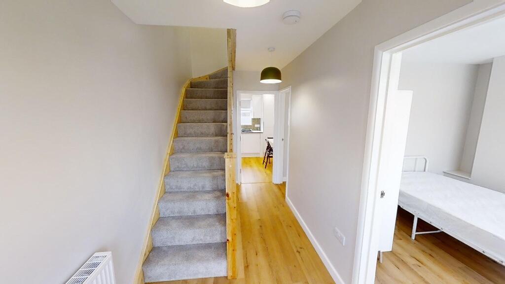 Bright and clean hallway with light wooden floo...