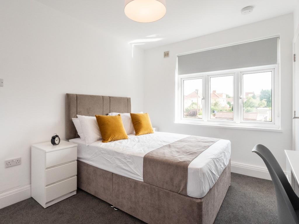 This inviting double bedroom features a comfort...