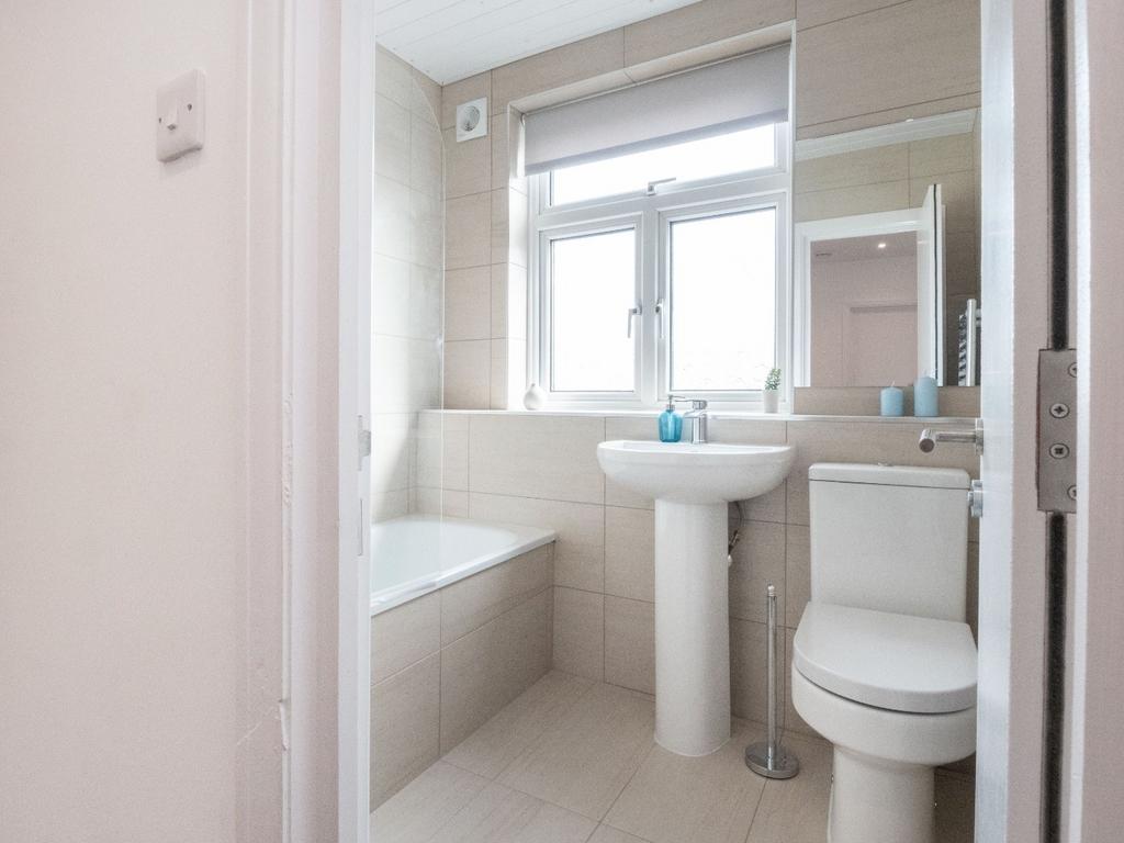 A bright and tidy bathroom featuring modern fix...